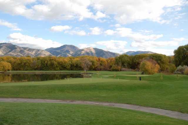 A fall view of the practice area with mountains in backgrouns at Logan River Golf Course