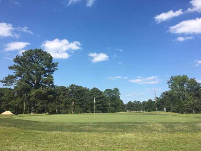 A sunny day view of a green at Twin Lakes Golf Club.
