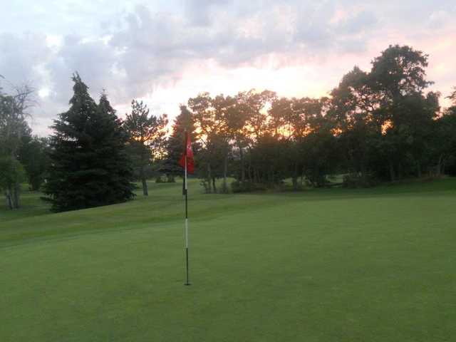 A sunset view of a green at Fox Hollow Golf Course.