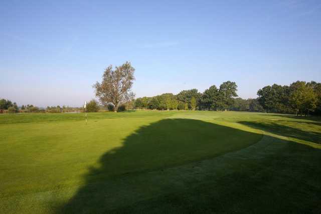A sunny view of a green at Slinfold Golf & Country Club