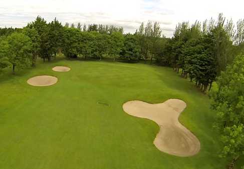 A view of a green protected by tricky sand traps at Tuam Golf Club