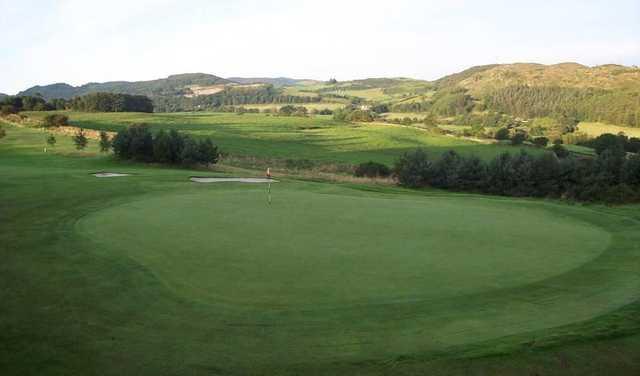 A view of a green protected by bunkers at Dalbeattie Golf Club