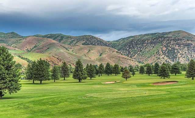 A view of a tee and a green in background at Round Valley Golf Course.