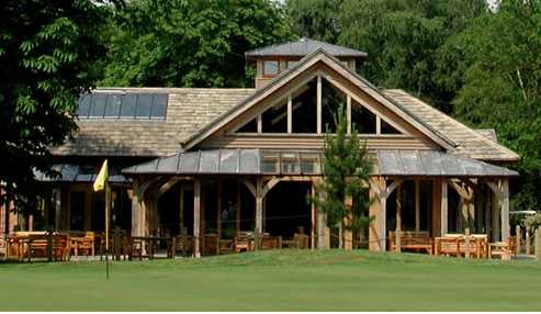 A view of the clubhouse with green in foreground at Peover Golf Club