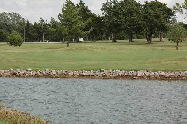 A view over the water of a hole at Cedar Valley Golf Club