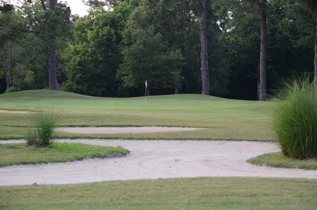 A view of a green protected by bunkers at Decatur Country Club