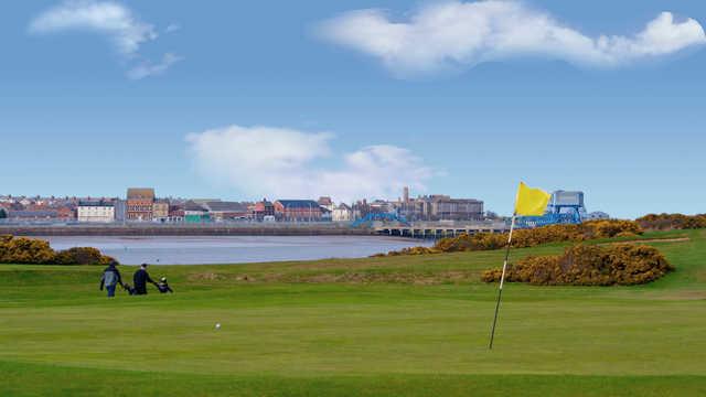 A view of a green with water in background at Knott End Golf Club