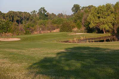 A view of a green with water and bunkers coming into play at Bethany Bay Golf Club