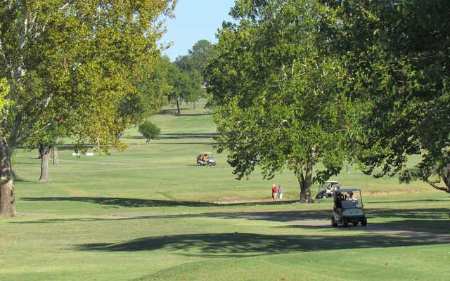 A sunny day view of a tee at Jimmie Austin Golf Course.