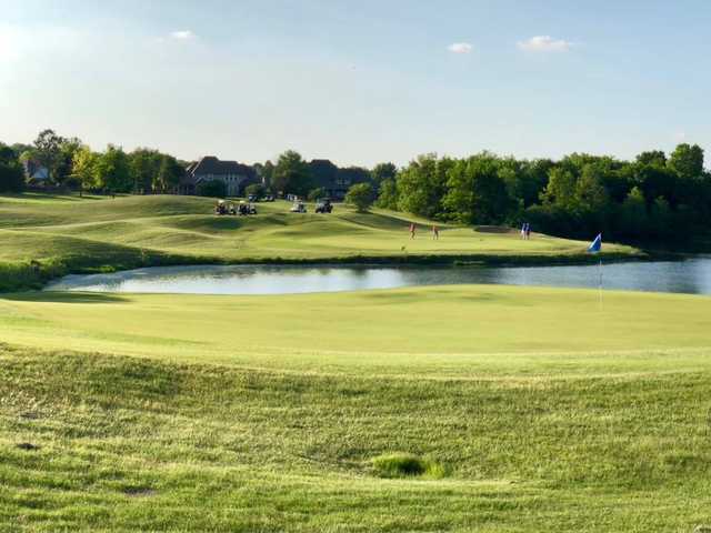 A sunny day view of a green at White Hawk Golf Club.
