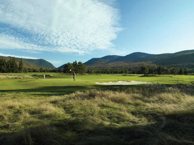 A view of a hole with mountains in background at Mount Washington from Mount Washington Hotel & Resort