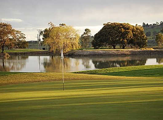 A view of the 16th green with water in background at Goonawarra Golf Club
