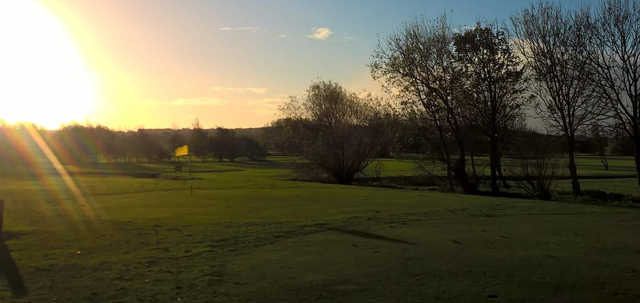 A sunny day view of a hole at Hoylake Golf Club.