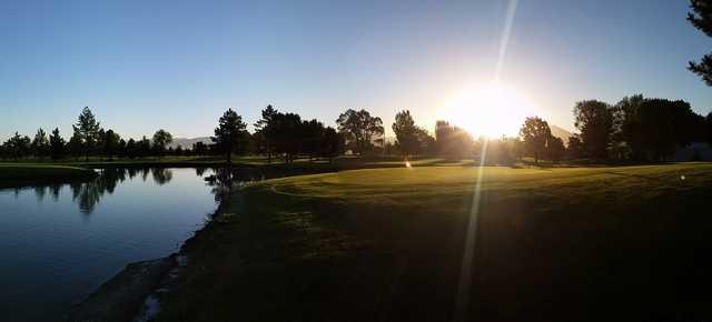 A sunny day view of a green at Fore Lakes Golf Course.
