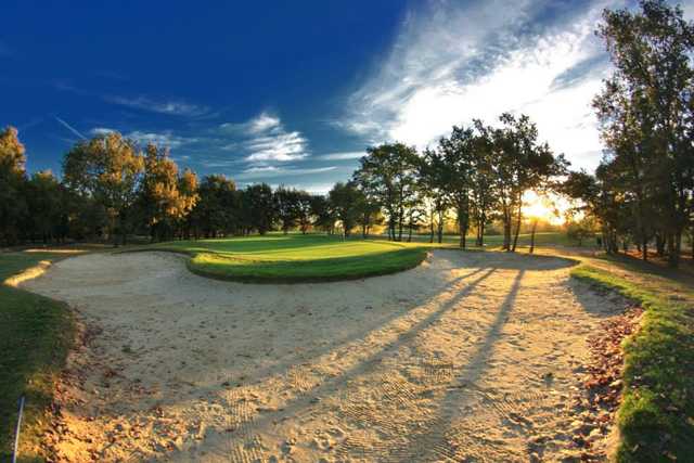 A view of a green surrounded by sand at Toulouse-La Ramee Golf Club