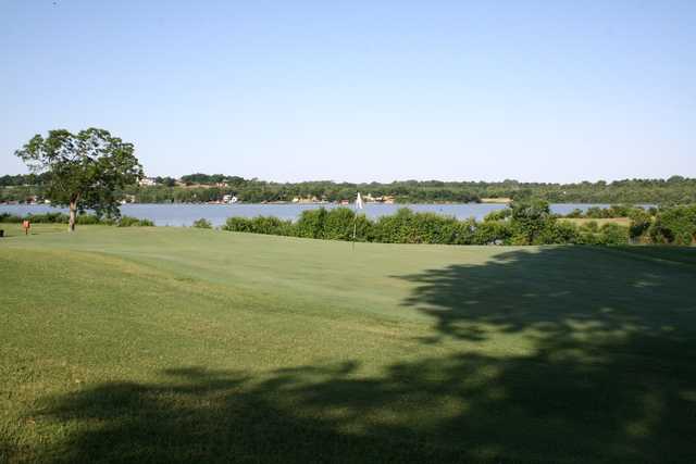A view of a hole with water in background at Lew Wentz Golf Course
