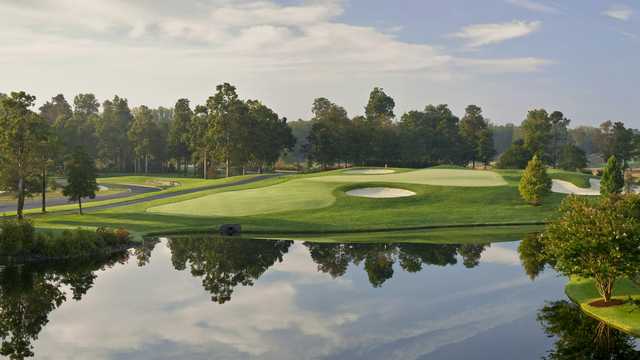 A view of the 15th green surrounded by water at Baywood Greens