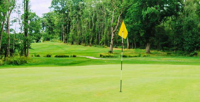 A view of a hole with a cart path in background at Horsham Golf Club.