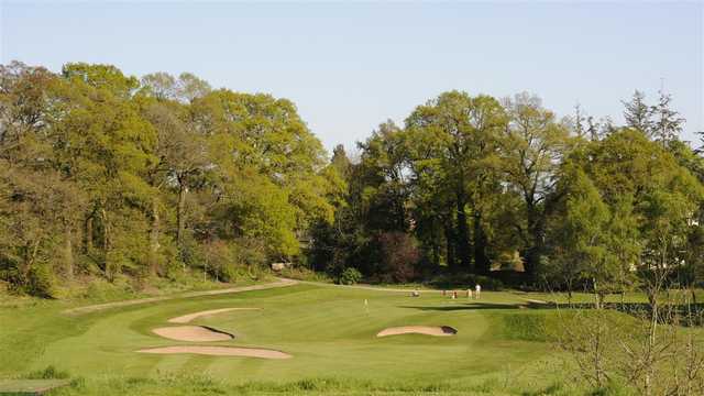 A view of a hole surrounded by bunkers at Dumfries and County Golf Club.