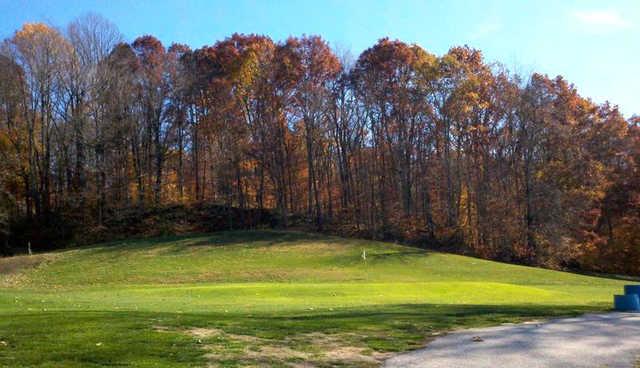 A fall day view of a green at Pine Woods Golf Course