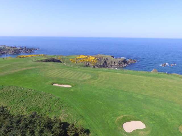 A view of a hole with water in the distance at Royal Tarlair Golf Club.