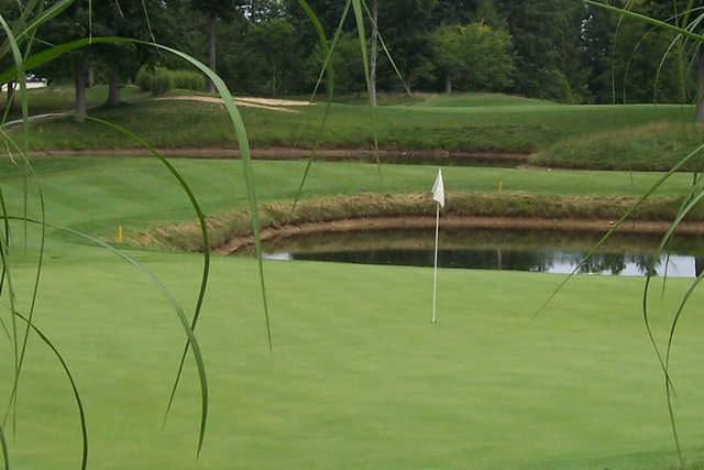 A view of a green protected by a pond at Hillcrest Country Club