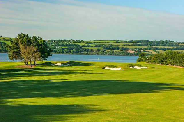 A view of a green with water in background at Cork Golf Club.
