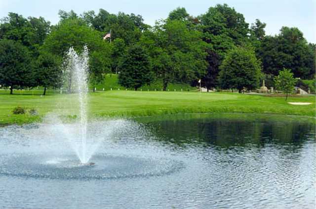 A view of a green with water fountain in foreground from Frankfort Commons Golf Course