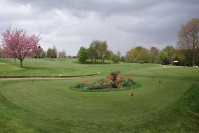 The practice green and 1st hole next to a beautiful blossom tree at Chesterfield Golf Club
