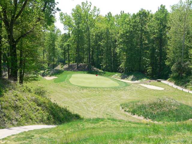 A view of a green protected by tricky bunkers at Quail Crossing Golf Club