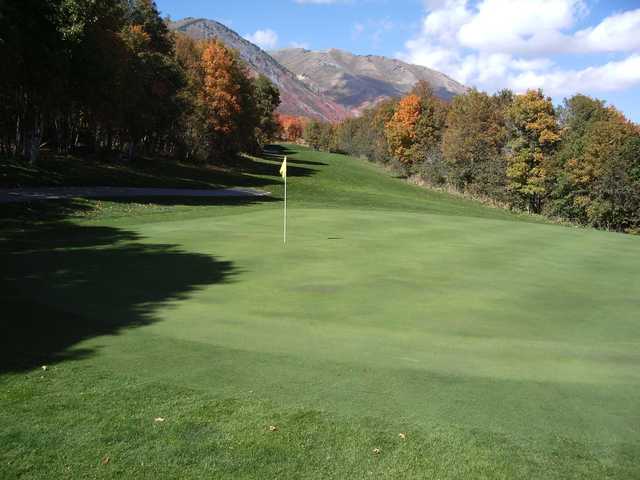 A sunny day view of a hole at Sherwood Hills Golf Course