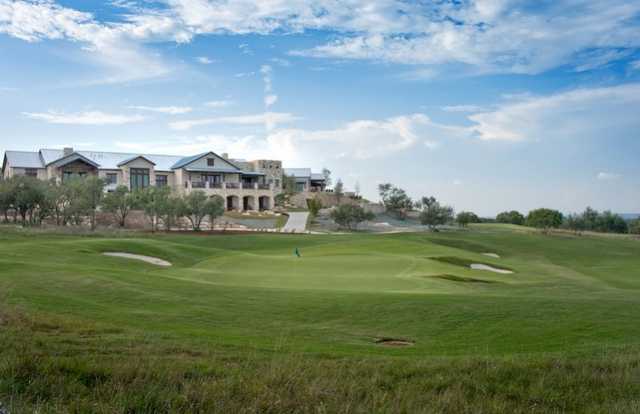 A view of the clubhouse with a green in foreground at Cordillera Ranch Golf Course