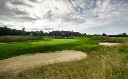 A view of a green with the clubhouse in background at Batchworth Park Golf Club