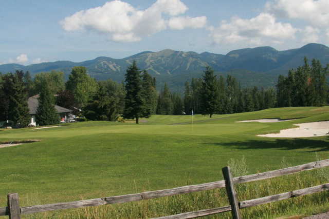 A view of a green protected by a collection of bunkers at Whitefish Lake Golf Club