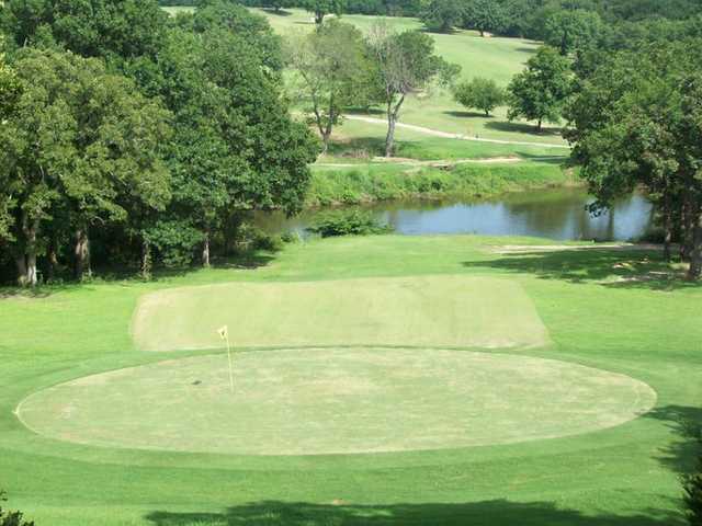A view of green with water in background at Lakewood Golf Course
