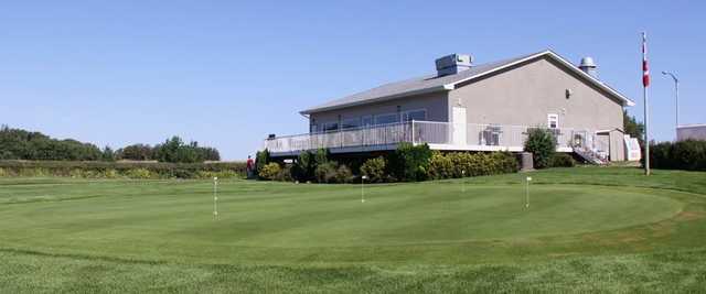 A view of the clubhouse and practice putting green at Sandhills Golf and Country Club