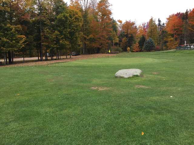 A fall day view of a green at Woodbury Golf Course.
