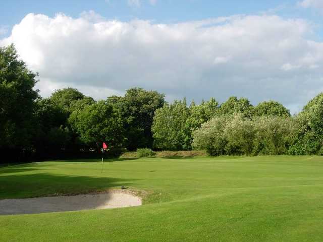 A view of a green protected by a bunker at Stepaside Golf Course