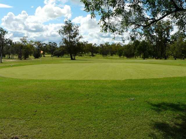 A sunny day view of a green at Roma Golf Club.