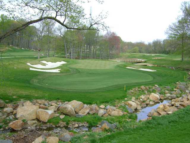 A view of a green flanked by sand traps at Rock Manor Golf Club