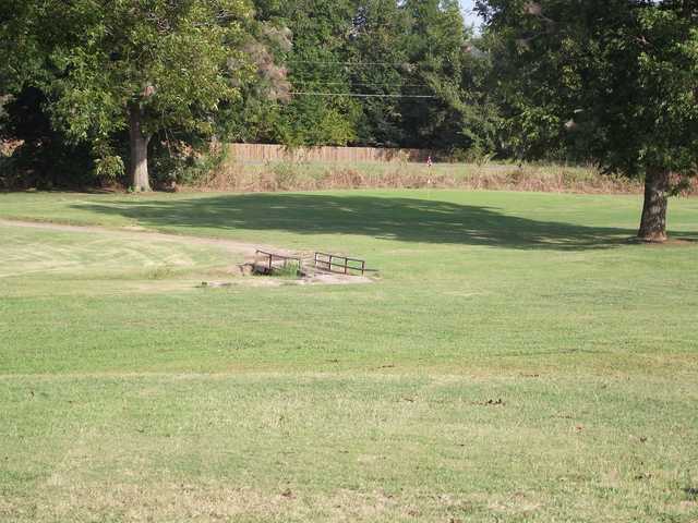 A sunny day view of a hole at Pecan Valley Golf Course