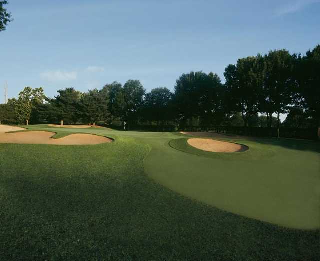 A view of the 12th green protected by sand traps at Cedar Ridge Country Club