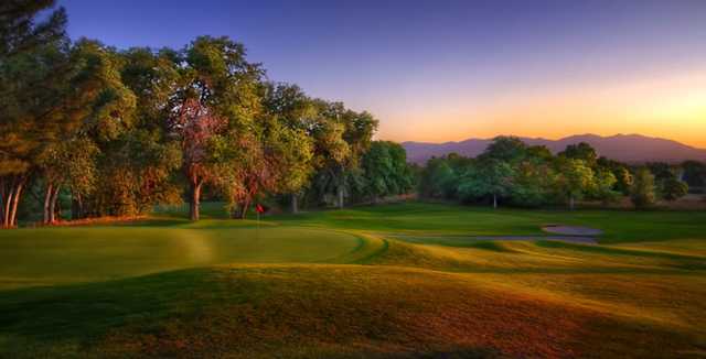 A sunset view of a green at Bonneville Golf Course.