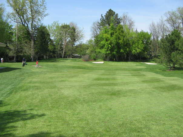 A view of green flanked by bunkers at Cottonwood Country Club