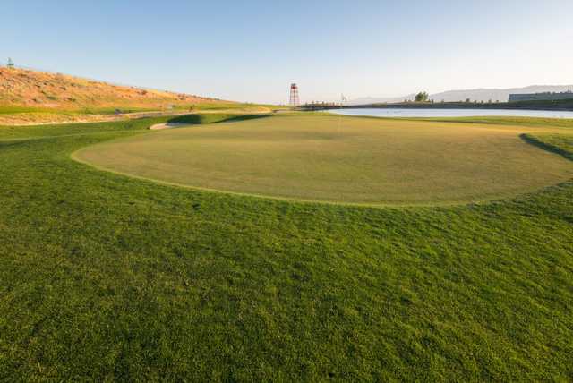 A view of a green with water in background at Ridge Golf Club