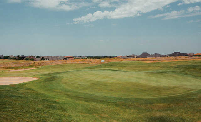 A sunny day view of a green at Rose Creek Golf Club.