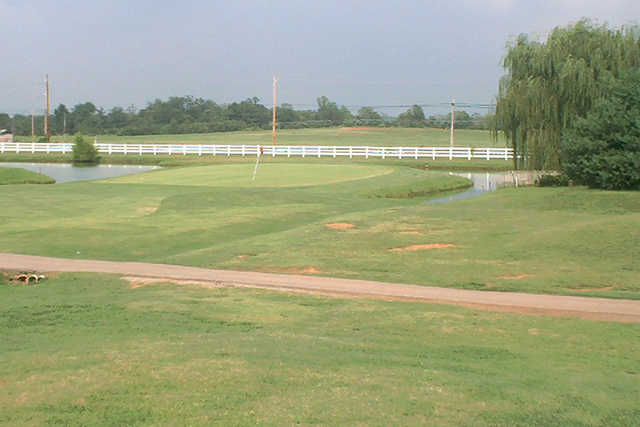 A view of a green surrounded by water at Fox Run Golf Course