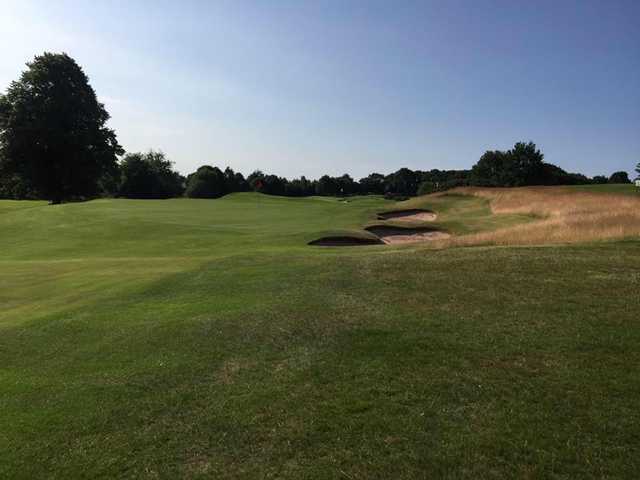 A sunny day view of a green at Warrington Golf Club.