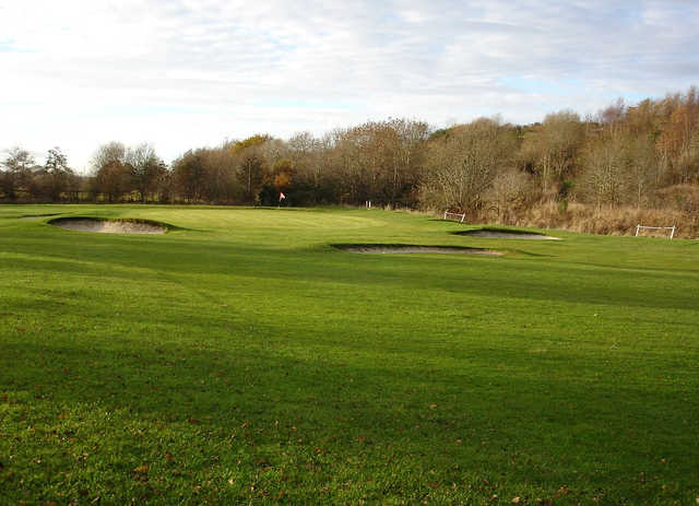 A view of a green surrounded by a collection of bunkers at Bridgend Golf & FootGolf.