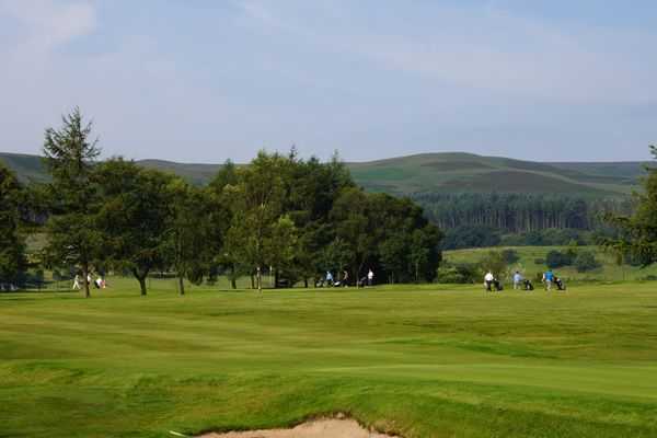 Lush fairways protected by bunkers at Dunscar Golf Club